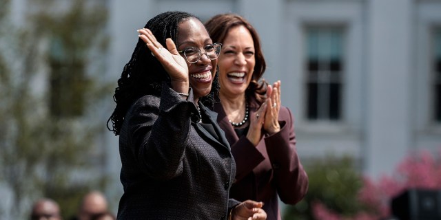 Judge Ketanji Brown Jackson smiles as Vice President Kamala Harris applauds at an event celebrating her confirmation to the U.S. Supreme Court on the South Lawn of the White House