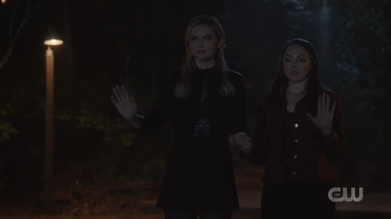 Legacies: Lizzie and Hope aka Hizzie hold hands on the dock in the dark 