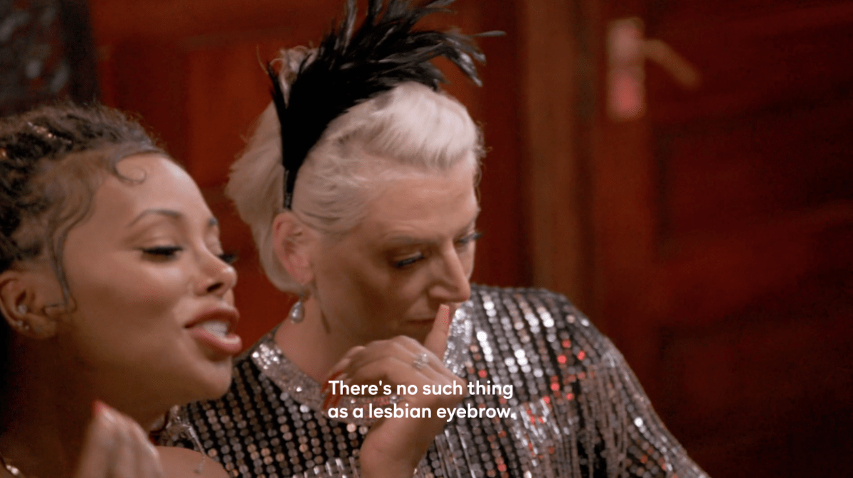 Eva Marcille, a Black woman, says "There's no such thing as a lesbian eyebrow" on Ultimate Girls Trip. She's sitting next to Dorinda Medley, a white woman.