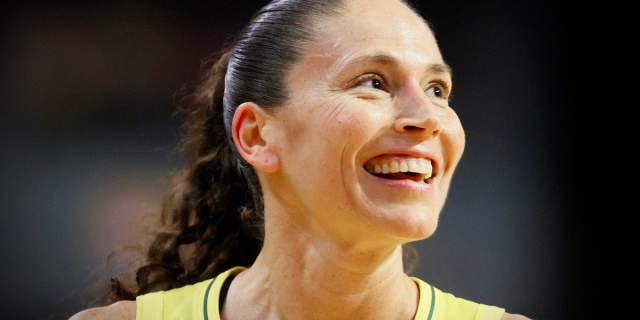 A close up of Sue Bird smiling during a WNBA basketball game.