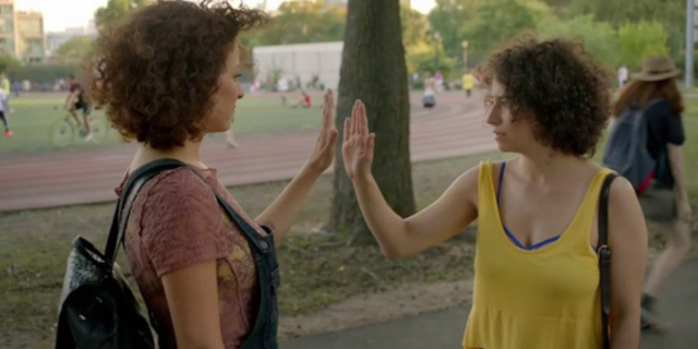 Alia Shawkat and Ilana Glazer hold their hands up to each other on Broad City.