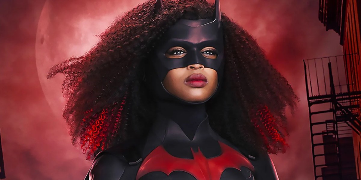 picture of javicia leslie as batwoman looking off screen right with a dark red gotham background behind her