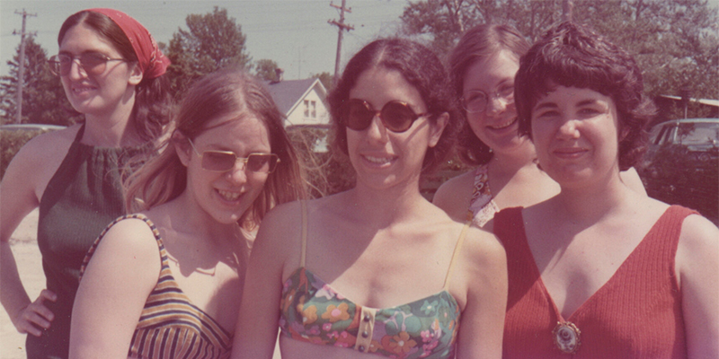 The Janes in their swimwear posing for a photo