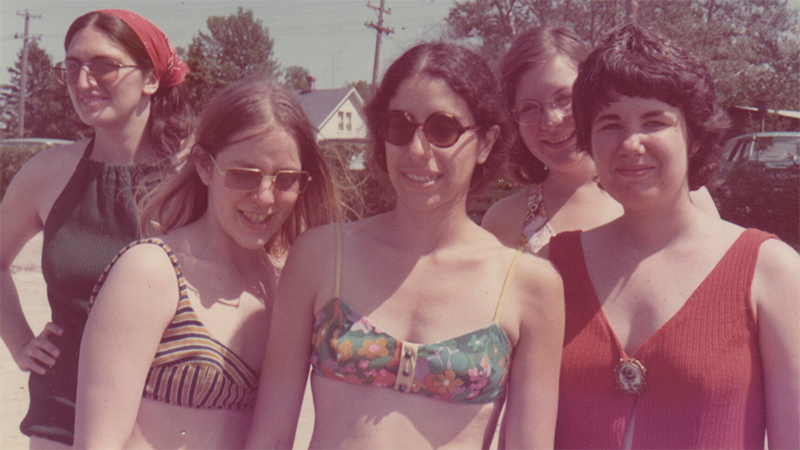 The Janes in their swimwear posing for a photo