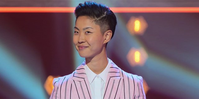 Kristen Kish on the set of Iron Chef in a pink pinstripe suit