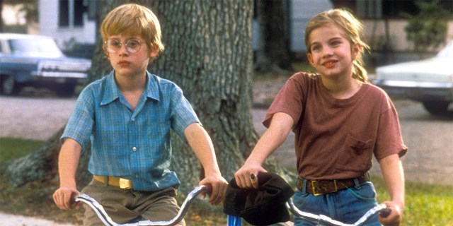 Anna Chlumsky and Macaulay Culkin on bicycles in a still from My Girl