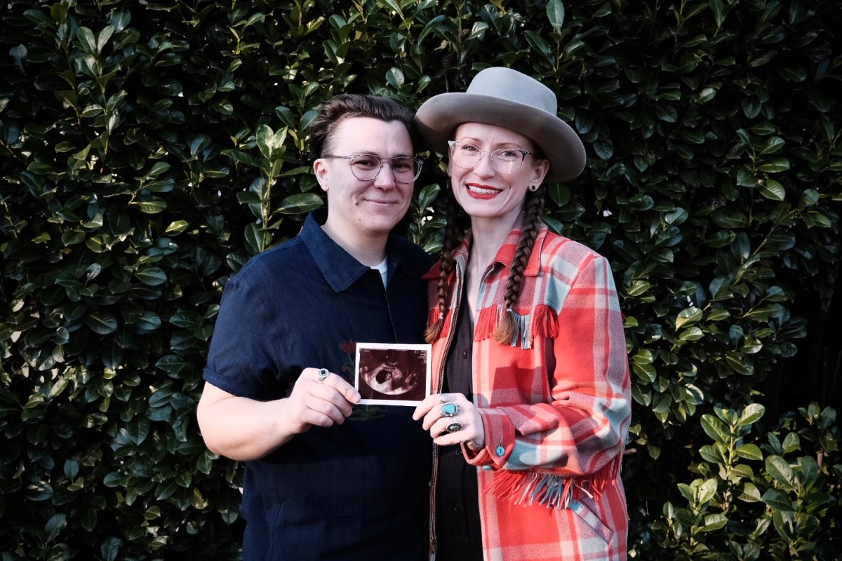 Oshin and Torre holding an ultrasound photo.