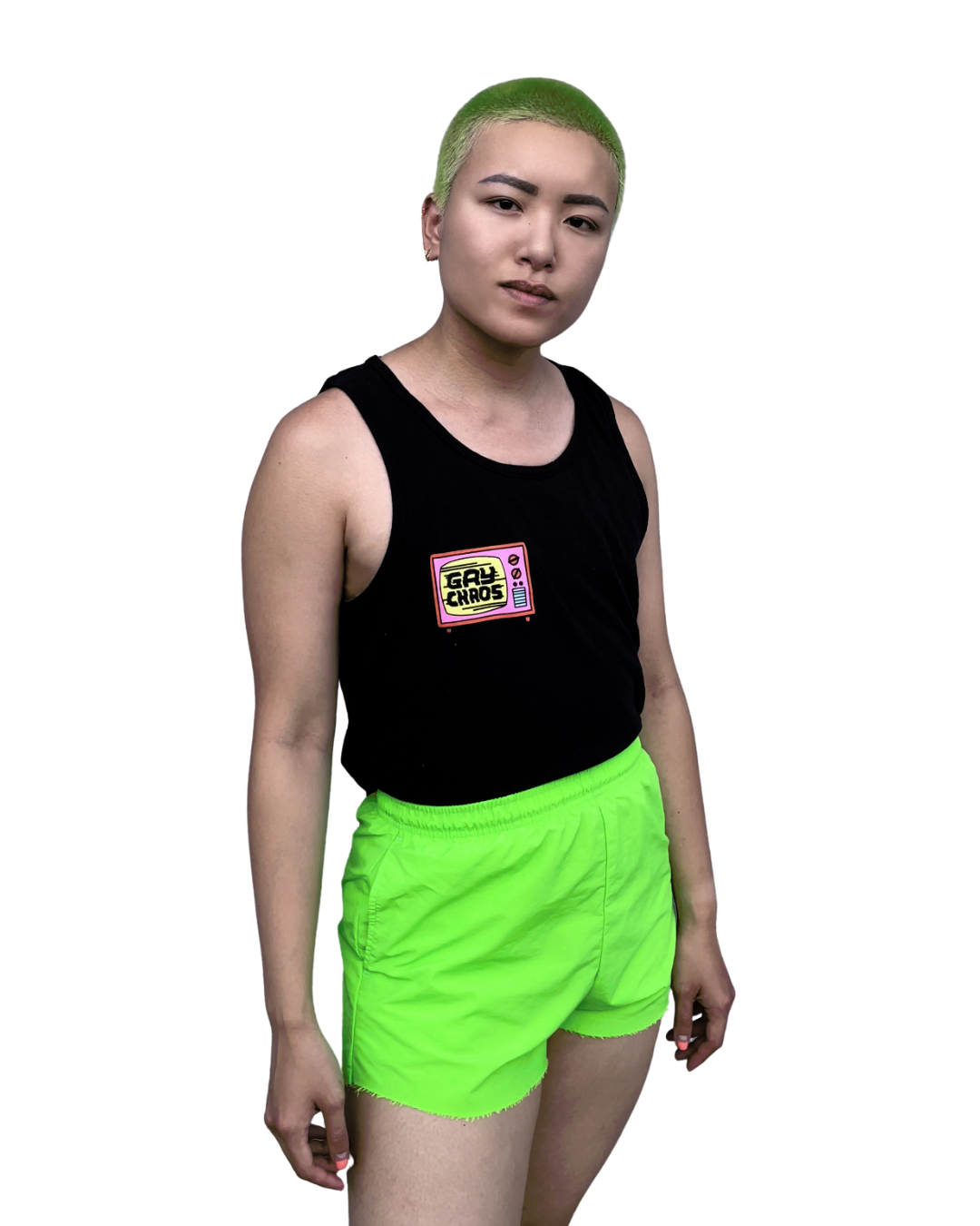 Viv is wearing the Gay Chaos black tank top. They have green buzz hair and are wearing bright green shorts.