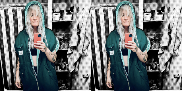 Niko is a tall trans woman with white-blonde hair and shaggy bangs, she is in a turquoise blue zip up hoodie sweatshirt with a matching black sports bra and high waisted biker shorts underneath. She is collaged in front a pixelated black and whit photo of her bathroom.