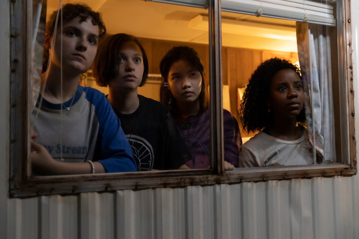 4 teen girls stare out of a trailer window
