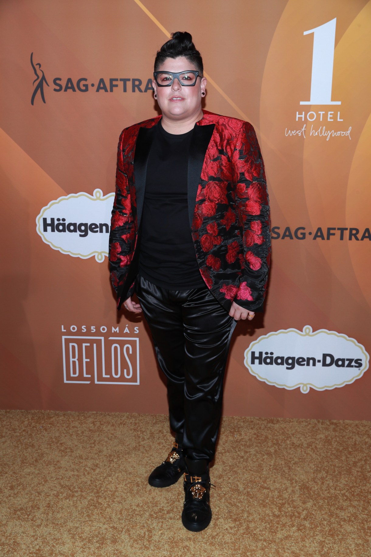 Ser Anzoategui in a suit with shiny black pants and a velvet blazer