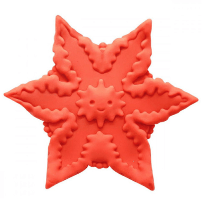 A pink, starfish-shaped silicone sex toy with a small smiling face in the middle is against a white background.