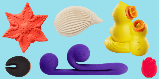 Six sex toys are against a light blue background. One is shaped like a pink starfish with a face on it; another is shaped like a black fortune cookie with a light pink stripe along the bottom; another is a dual-stimulation purple two with a long stem with a sphere at the end and a shorter stem with another, curved sphere at the end; another is shaped like a white seashell; two are shaped like yellow ducks with orange beaks and the last one is shaped like a bright pink rose.