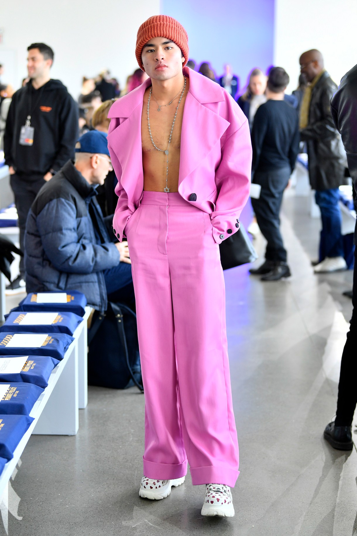 Chella Man in a hot pink suit with chunky shoes