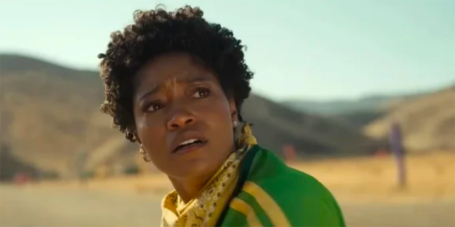 Keke Palmer in a green track jacket and yellow bandana tied around her neck in NOPE
