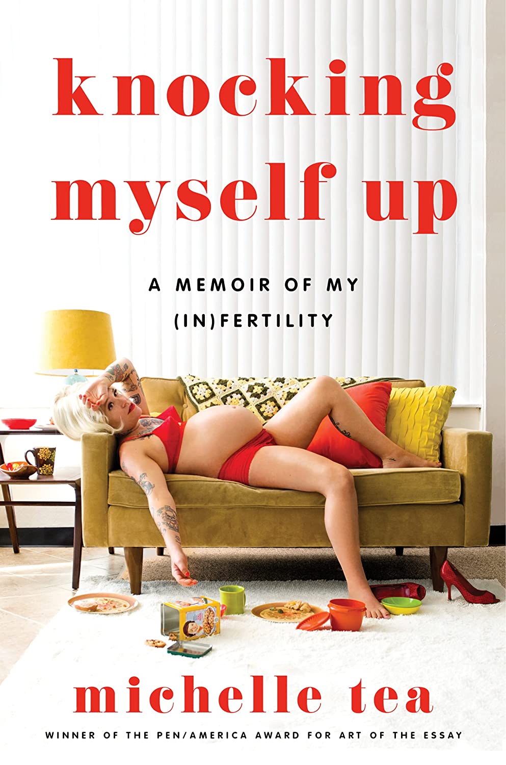 the cover of Knocking Myself Up a memoir of my (in)fertility by Michelle Tea shows the author in red lingerie reclining on a couch, pregnant belly facing upward. She has on arm dramatically draped on her forehead.