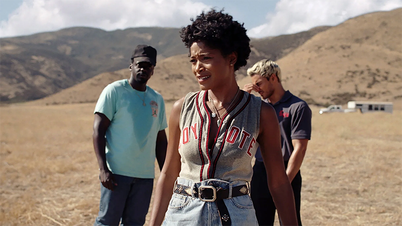 Keke Palmer in a jersey standing in the desert with her brother and a tech guy