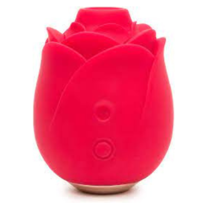 A bright pink silicone sex toy shaped like the head of a rose is against a white background. Two small buttons are on the front of the toy.