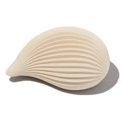 A white, silicone sex toy shaped like a ribbed seashell is against a white background.