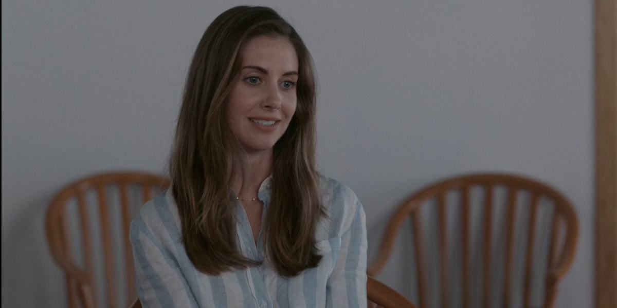 Alison Brie talking in a linen shirt that is slightly unbuttoned