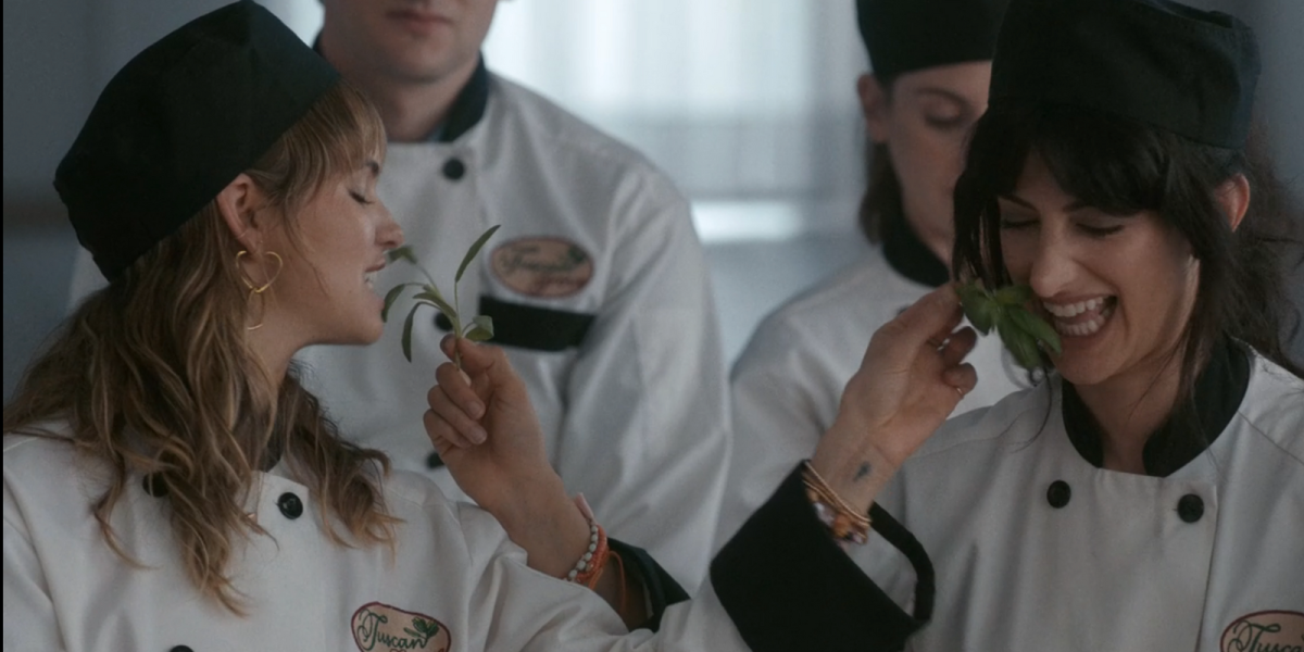 Two girls playing with herbs putting them in each others mouth