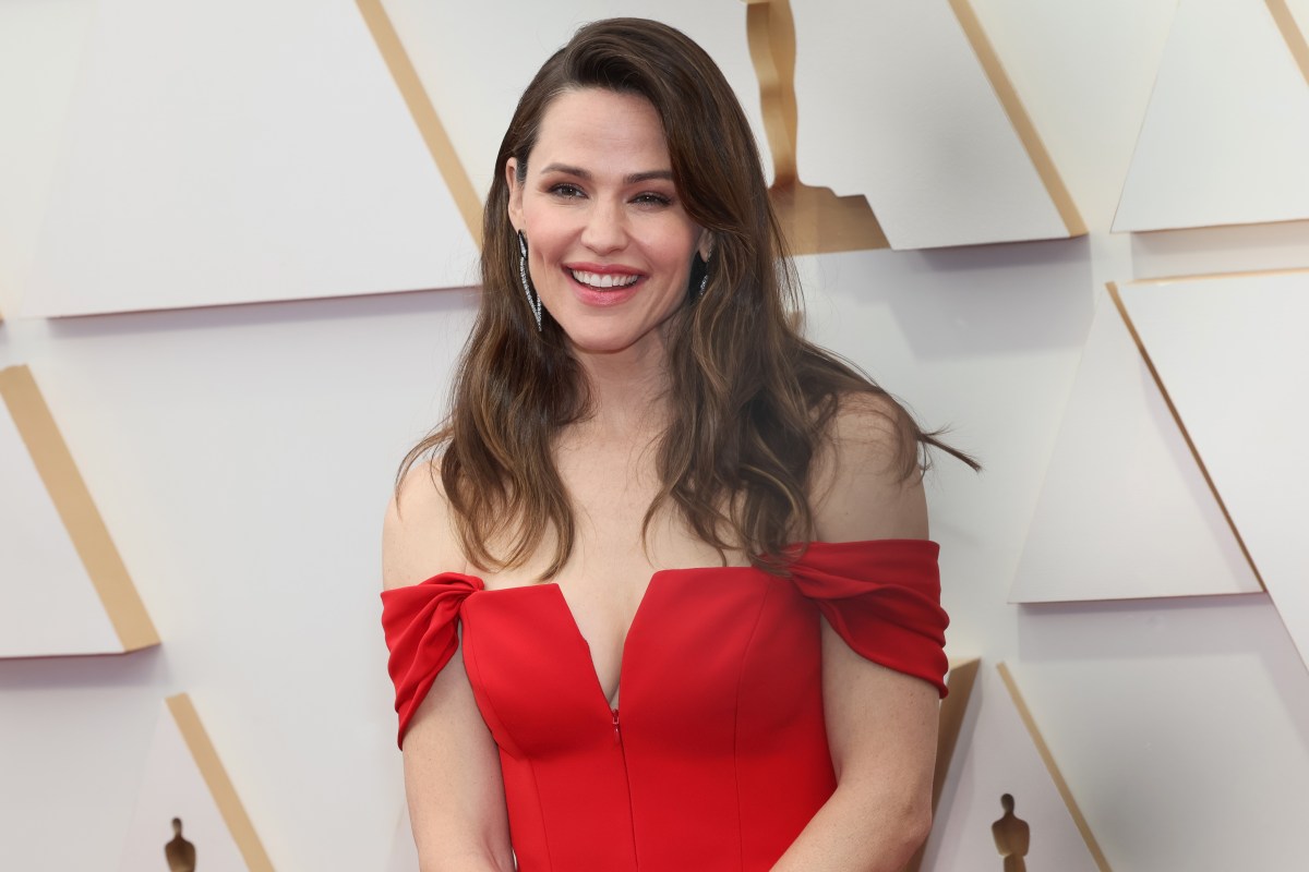HOLLYWOOD, CALIFORNIA - MARCH 27: Jennifer Garner attends the 94th Annual Academy Awards at Hollywood and Highland on March 27, 2022 in Hollywood, California. Jennifer Garner is a white woman with long brown hair wearing a red dress in this photo.