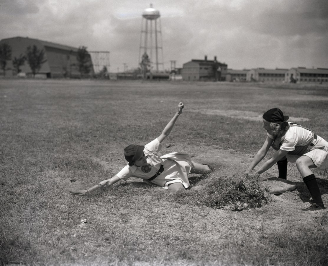 (Original Caption) 4/8/1948-Opa Locke, FL: Sophie Kurys of Flint, MI, member of the Grand Rapids, MI, Chiks, demonstrates her sliding ability during spring training here for teams of the All-American Girls Baseball League. She was the league's base-stealing champ last year. Covering the plate is Ruth Lessing of San Antonio, TX, Chicks' catcher.