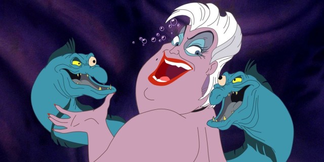 Ursula from The Little Mermaid is singing directly to camera with her pet eels on either side.