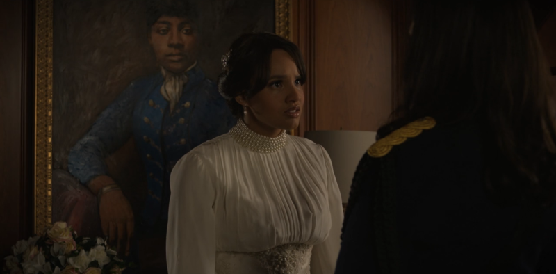 Abigail stands in front of her ancestor's portrait