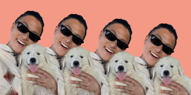 Chef Melissa King holds a white fluffy puppy while wearing sunglasses and smiling
