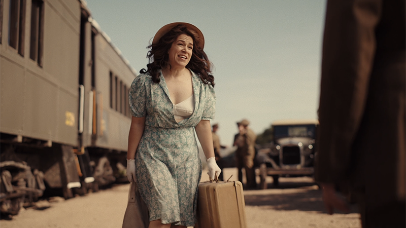 A League of Their Own Recap: Carson Shaw stands on a train platforms with her dress accidentally unbuttoned 