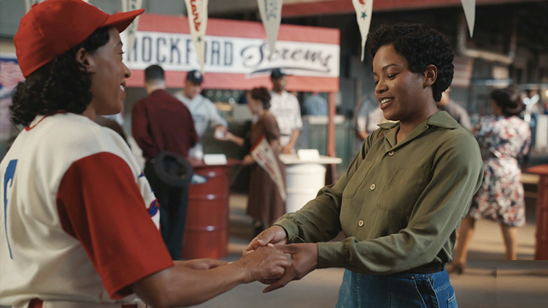 Max hands Esther a baseball to sign. 