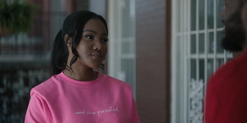 Wearing a pink "and she persisted" sweatshirt, Fatima listens to Victor's latest excuse for why they can't be a real couple on the stoop outside her apartment.