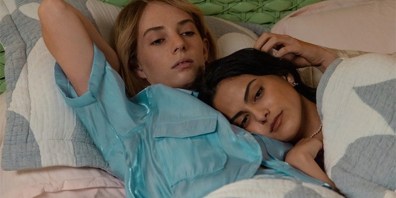 Maya Hawke and Camila Mendes cuddled in bed in Do Revenge