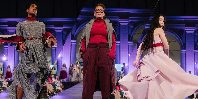 Three queer humans at the dapper q fashion show walking the runway: a black femme person with short hair in a dress, a white masc person in a red turtleneck and slacks, a femme Asian person in a pink dress. The runway is purple.