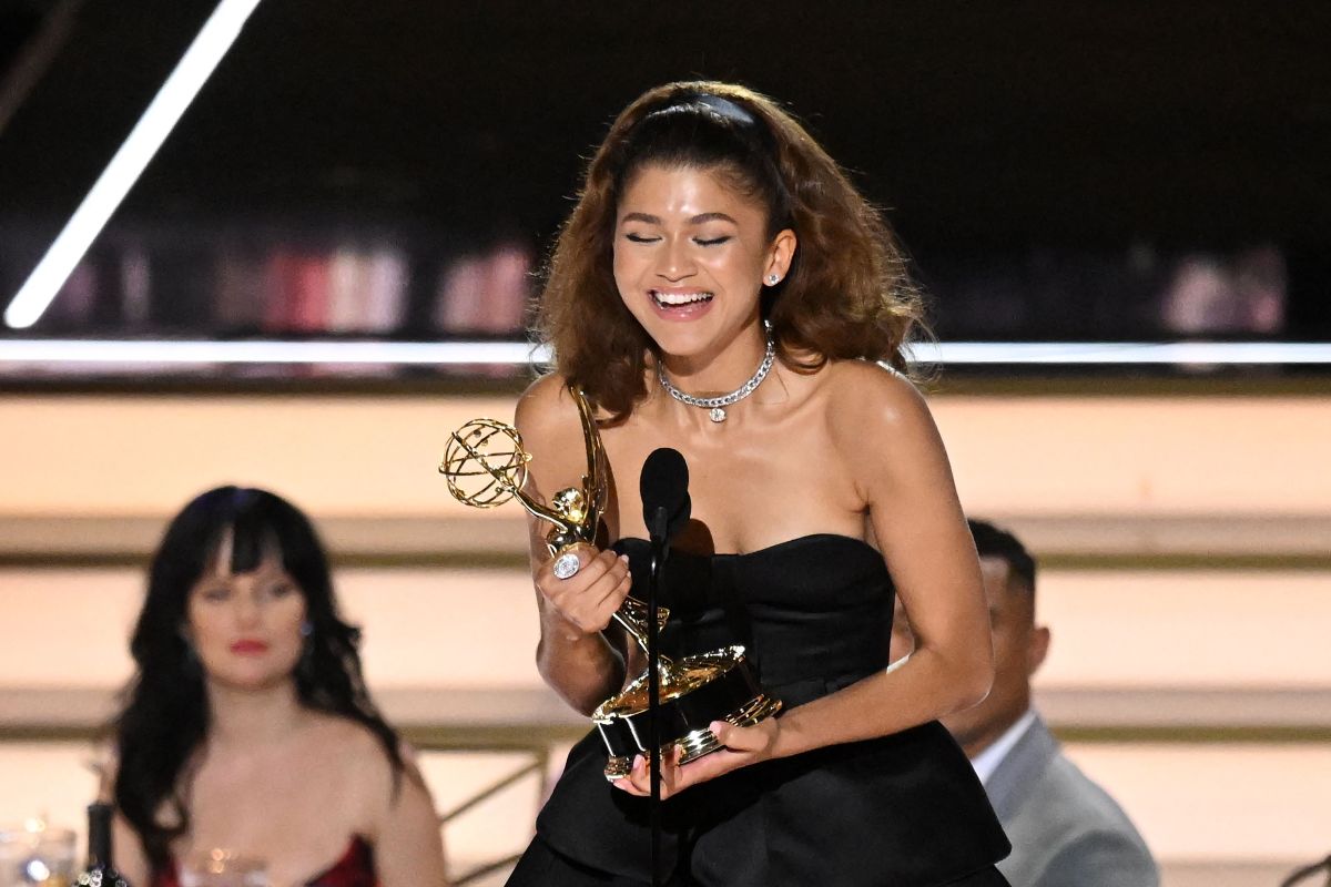 Zendaya in a black sleeveless gown onstage accepting her Emmy