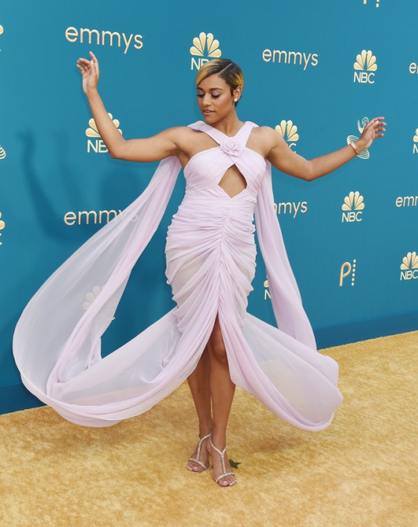 Ariana DeBose is in a purple chiffon dress and she's twirling for the camera.