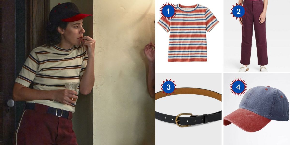 Lupe in A League of Their Own leans against a wall wearing a striped shirt, baseball hat, and burgundy pants. Products depicted: A striped multicolored t-shirt, burgundy pants, a black buckled belt, and a blue and red vintage baseball cap.