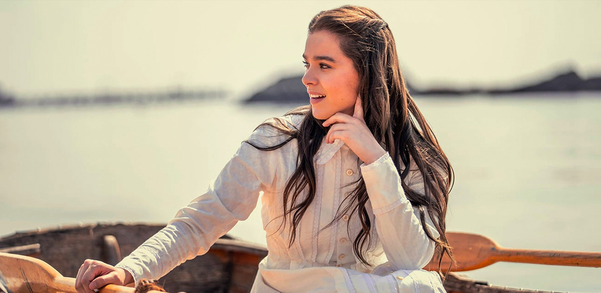 Hailee Steinfeld as Emily Dickinson sits in a row boat