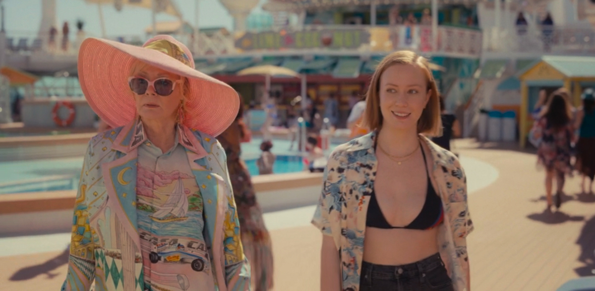 Deborah and Ava from Hacks walk beside each other on the deck of a cruise ship