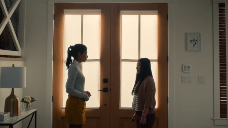 Abbi and Hannah talk nervously in front of the doorway