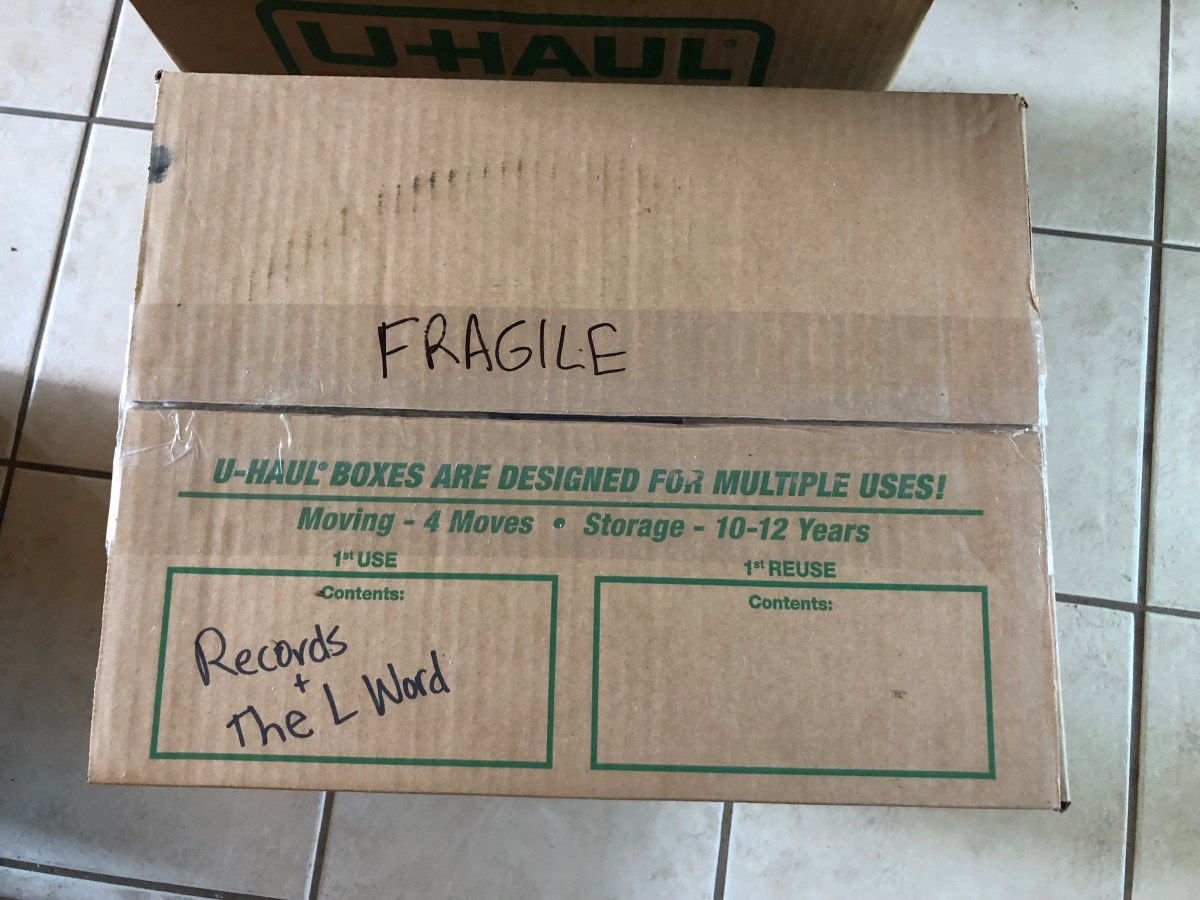 A moving box labeled RECORDS + THE L WORD
