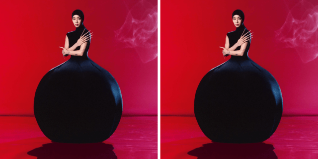 Sawayama in a large black gown that billows out into a ball shape against a red background.