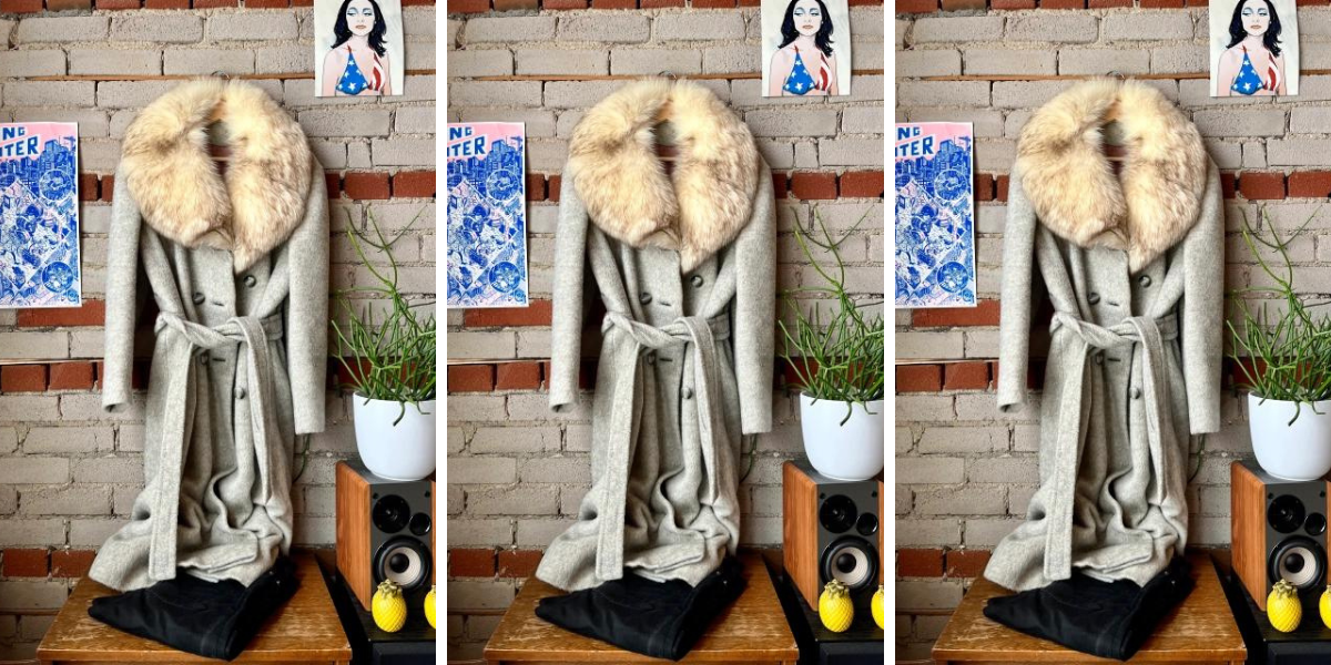 a brick wall, with a photo of PJ Harvey on the upper right corner and a power that says Long Winter to the left. Hanging on the wall is a grey long jacket with a fur collar