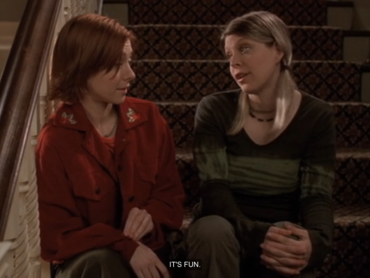 Willow and Tara sitting next to each other on a staircase.  Tara says "it's funny."