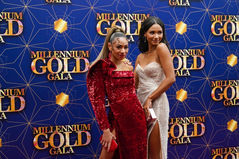 Patience, wearing a red gown, poses with Leyla on the red carpet of the Millennium Gold Gala.