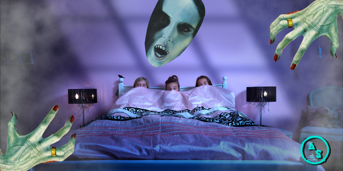 Three girls hide under a blanket while watching a scary movie in bed. A fanged monster woman's face hovers over them and creepy green hands with black nails reach from the corners