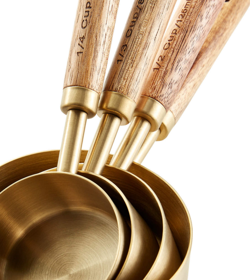 Measuring cups in gold with wood handles