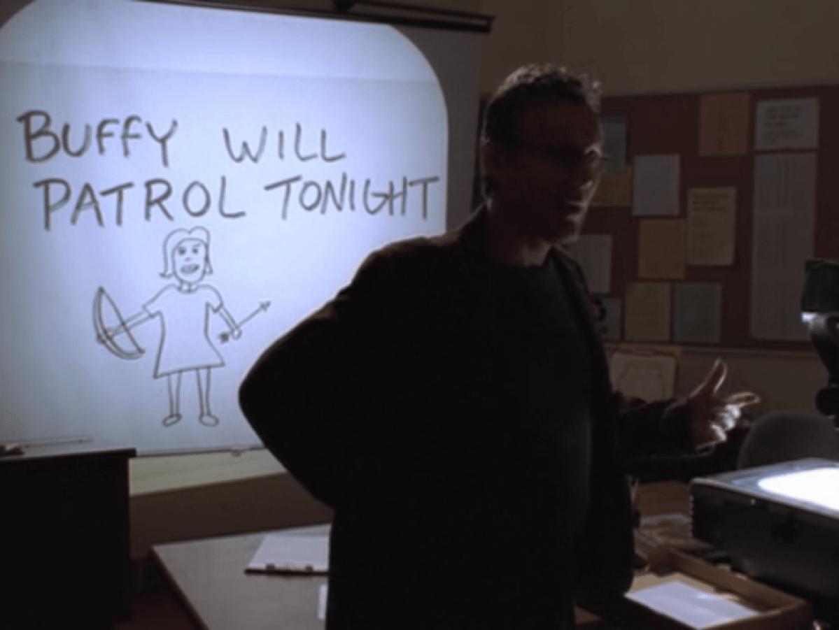 Giles standing in front of a poorly drawn transparency that says BUFFY WILL PATROL TONIGHT