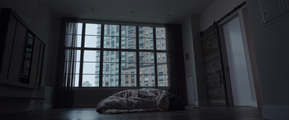 A sparse apartment with a bed on the floor